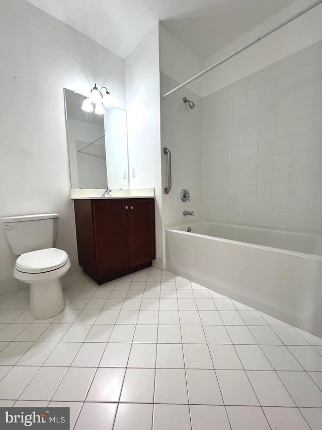 full bathroom featuring tile patterned flooring, tiled shower / bath combo, vanity, and toilet