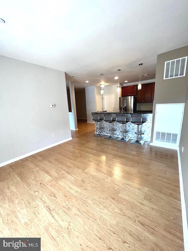 unfurnished living room featuring light hardwood / wood-style floors