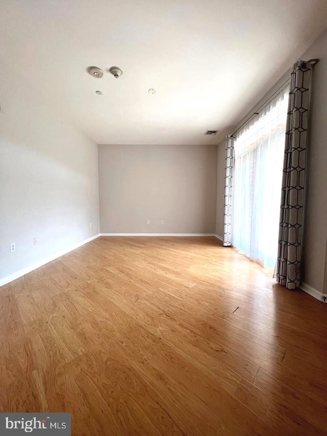 unfurnished room with light hardwood / wood-style flooring