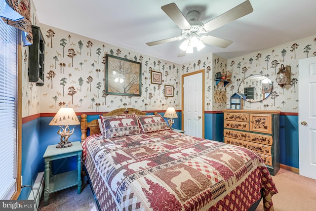 bedroom with carpet floors, a baseboard heating unit, and ceiling fan