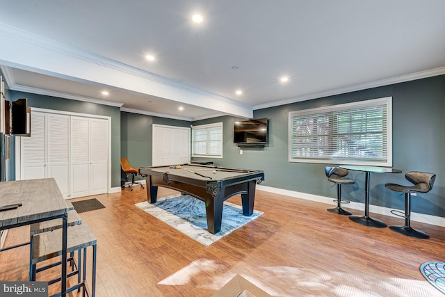 rec room featuring pool table, a healthy amount of sunlight, crown molding, and light hardwood / wood-style flooring