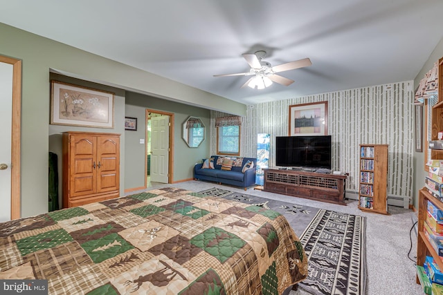 carpeted bedroom with ceiling fan and baseboard heating