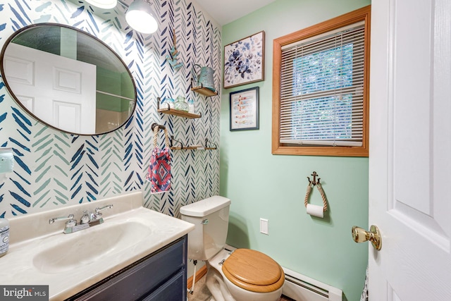 bathroom featuring baseboard heating, vanity, and toilet