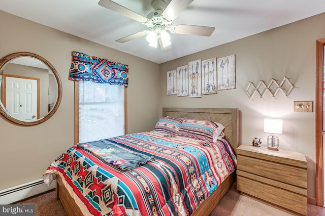 carpeted bedroom with a baseboard heating unit and ceiling fan