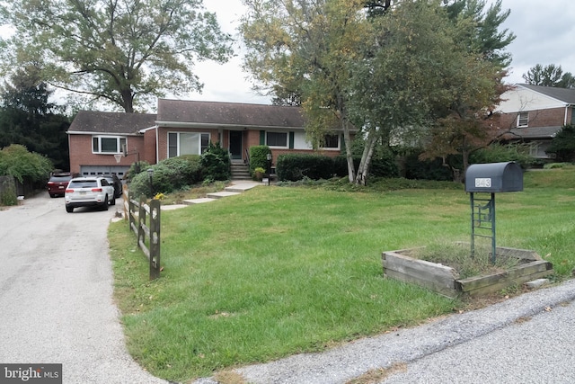 single story home featuring a garage and a front yard