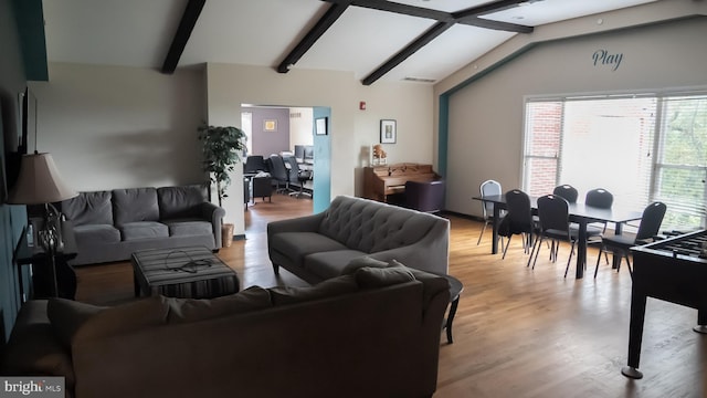 living room with lofted ceiling with beams and light hardwood / wood-style floors