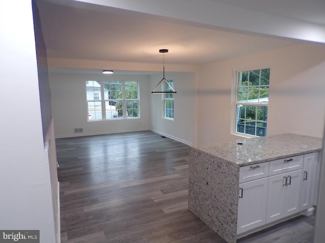 kitchen with white cabinets, plenty of natural light, dark wood-type flooring, and pendant lighting