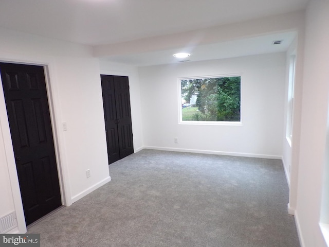 unfurnished room featuring carpet flooring