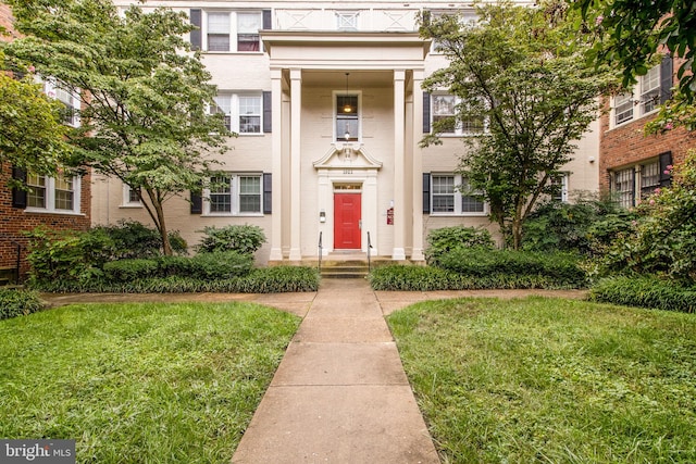 neoclassical home with a front lawn