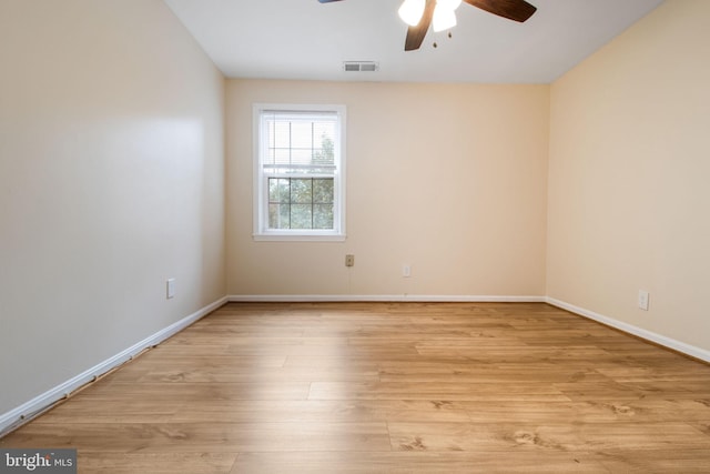 empty room with light wood-style floors, ceiling fan, baseboards, and visible vents