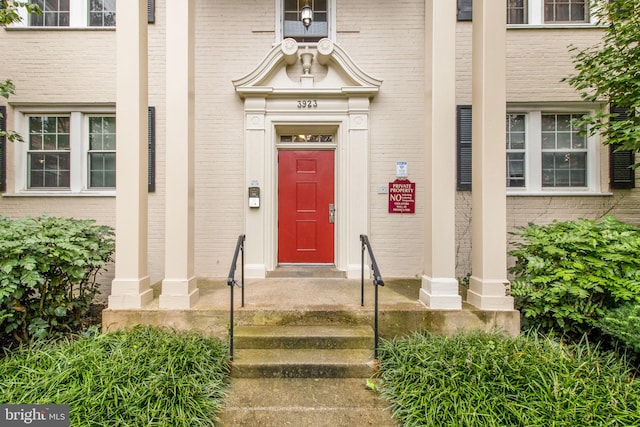property entrance with brick siding