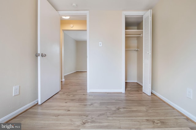 unfurnished bedroom with light hardwood / wood-style floors and a closet