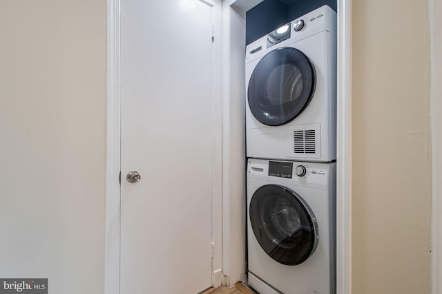 laundry room with stacked washer and dryer