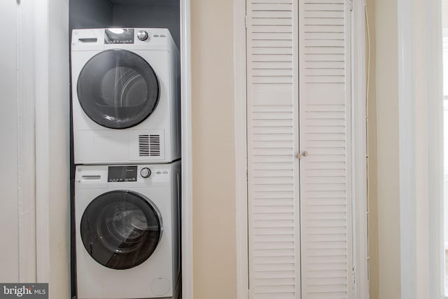 laundry room featuring stacked washing maching and dryer