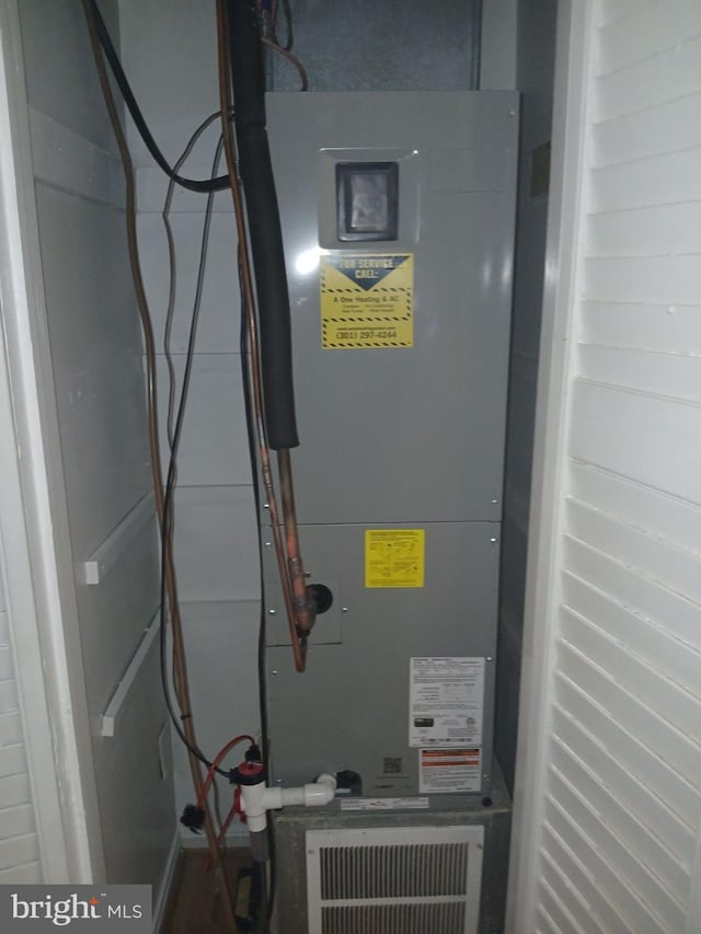 utility room featuring heating unit