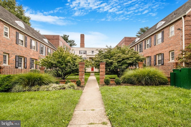 view of property's community with a lawn