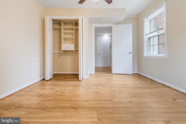 unfurnished bedroom featuring light wood-style flooring, a closet, ceiling fan, and baseboards
