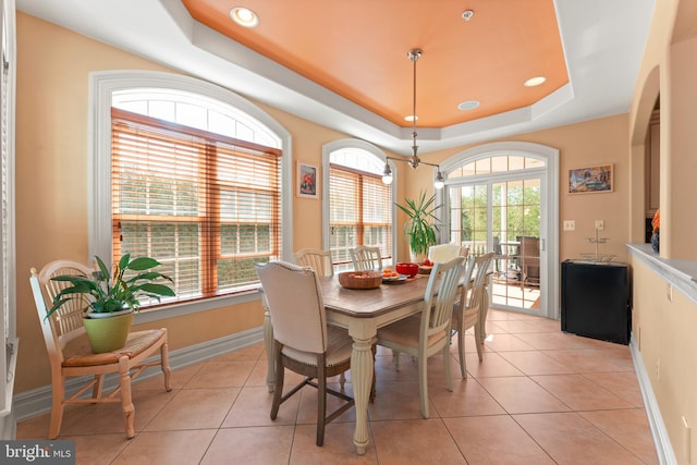 dining area featuring baseboards, recessed lighting, light tile patterned floors, and a raised ceiling