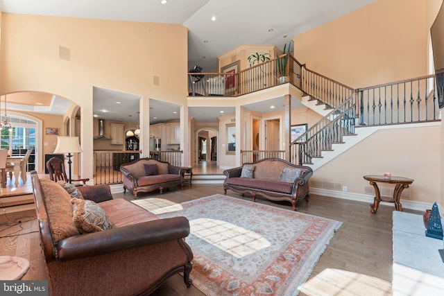 living room featuring light wood-type flooring and high vaulted ceiling