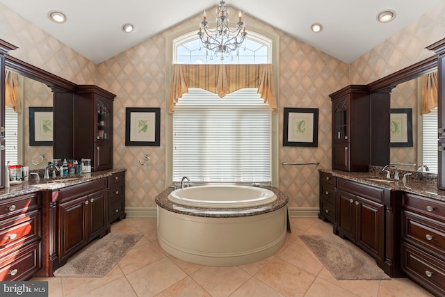 bathroom featuring an inviting chandelier, tile patterned flooring, a garden tub, and wallpapered walls