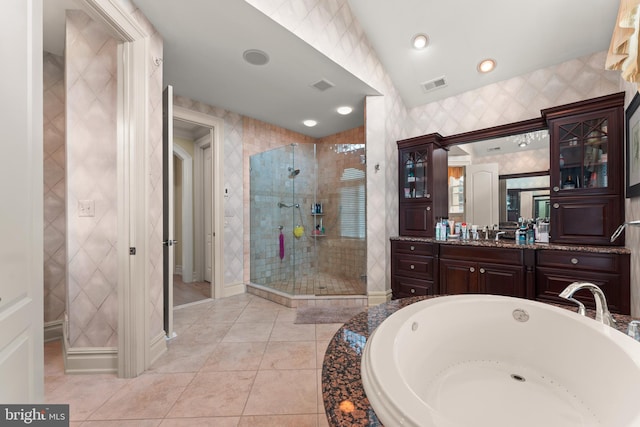 bathroom featuring a bath, visible vents, tile patterned floors, vanity, and a stall shower