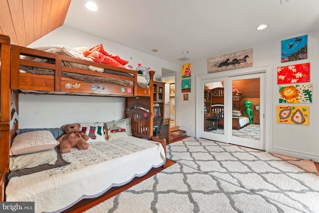 bedroom featuring vaulted ceiling and access to exterior