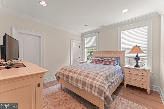 bedroom featuring light hardwood / wood-style flooring and crown molding