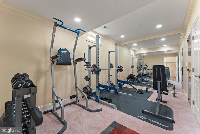 workout area with ornamental molding and light colored carpet