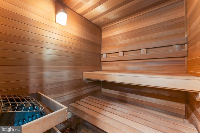 view of sauna / steam room featuring wood ceiling and wood walls