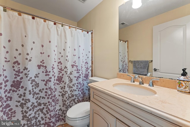 bathroom with visible vents, toilet, vanity, and a shower with curtain