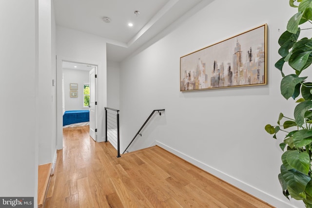 hallway with light hardwood / wood-style floors