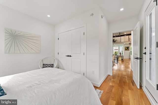 bedroom with light wood-type flooring and a closet