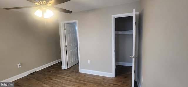 unfurnished bedroom with dark hardwood / wood-style flooring, a closet, and ceiling fan