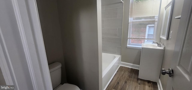 full bathroom with vanity, toilet, plus walk in shower, and hardwood / wood-style floors