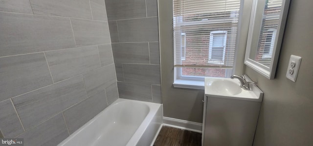 bathroom with vanity, a tub, and hardwood / wood-style flooring