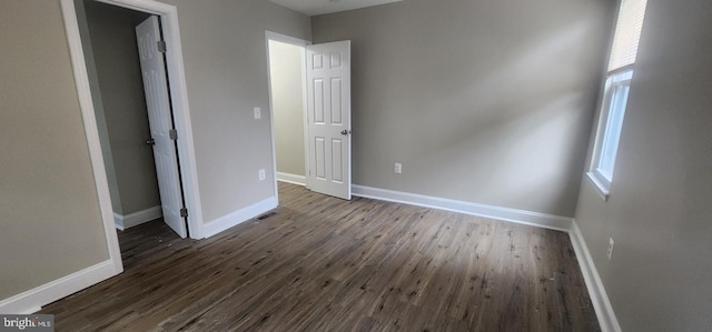 unfurnished bedroom featuring dark hardwood / wood-style flooring