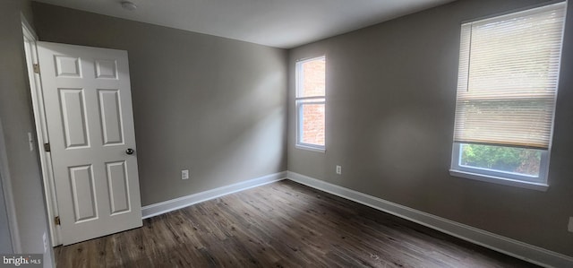 spare room featuring dark hardwood / wood-style flooring