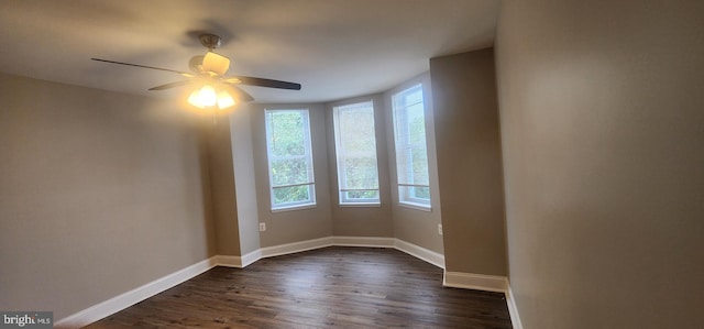 unfurnished room with dark wood-type flooring and ceiling fan