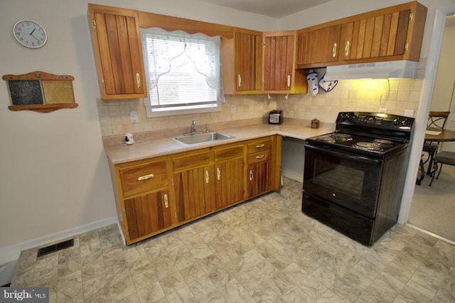 kitchen featuring backsplash, black electric range, and sink