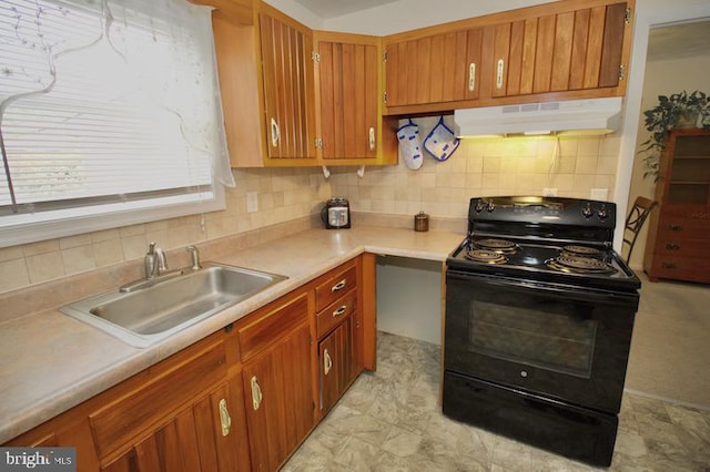 kitchen with black electric range oven, decorative backsplash, and sink