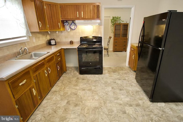 kitchen with ventilation hood, sink, decorative backsplash, and black appliances