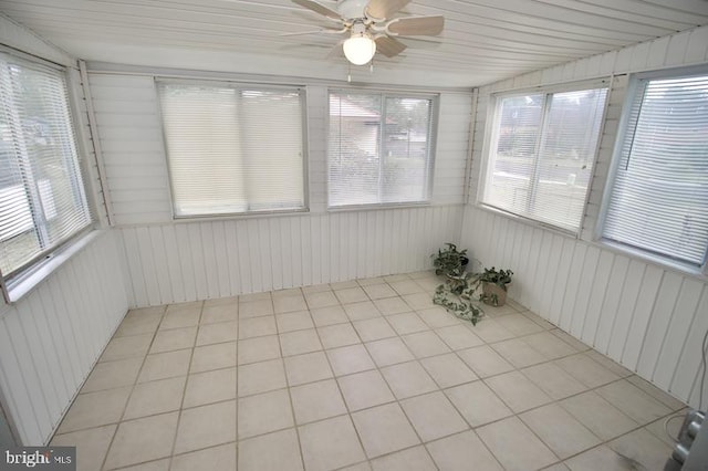 unfurnished sunroom featuring ceiling fan