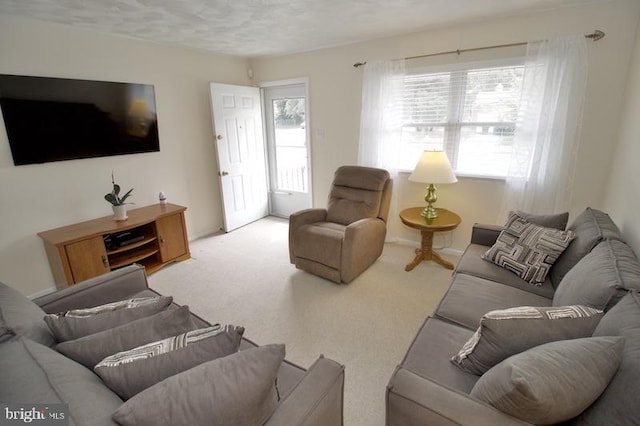 carpeted living room featuring a textured ceiling