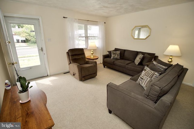 carpeted living room featuring a textured ceiling