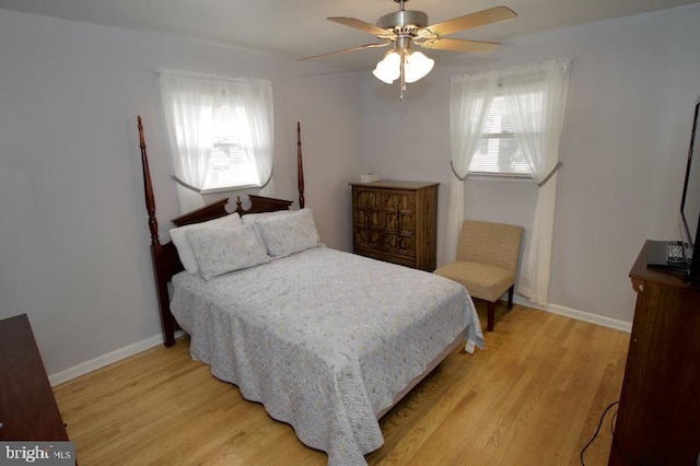 bedroom with light wood-type flooring and ceiling fan