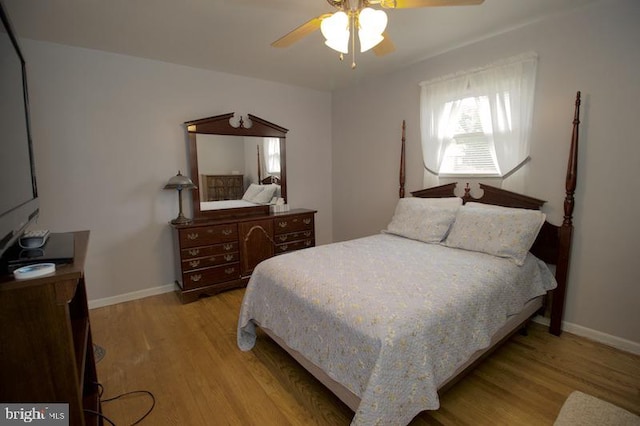 bedroom with ceiling fan and light hardwood / wood-style floors