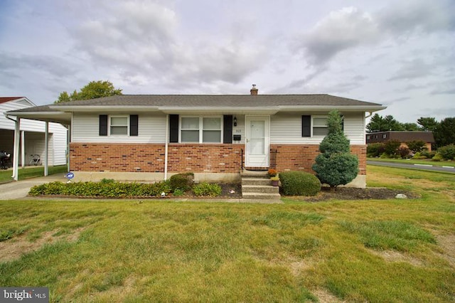 view of front of property with a front yard and a carport