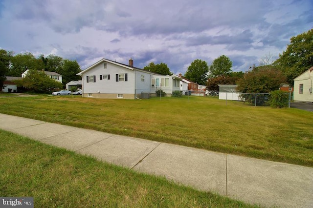 view of home's exterior featuring central AC and a yard