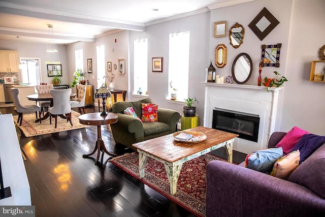 living room with dark hardwood / wood-style flooring, beamed ceiling, and ornamental molding