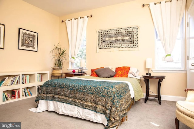 bedroom with carpet flooring and multiple windows